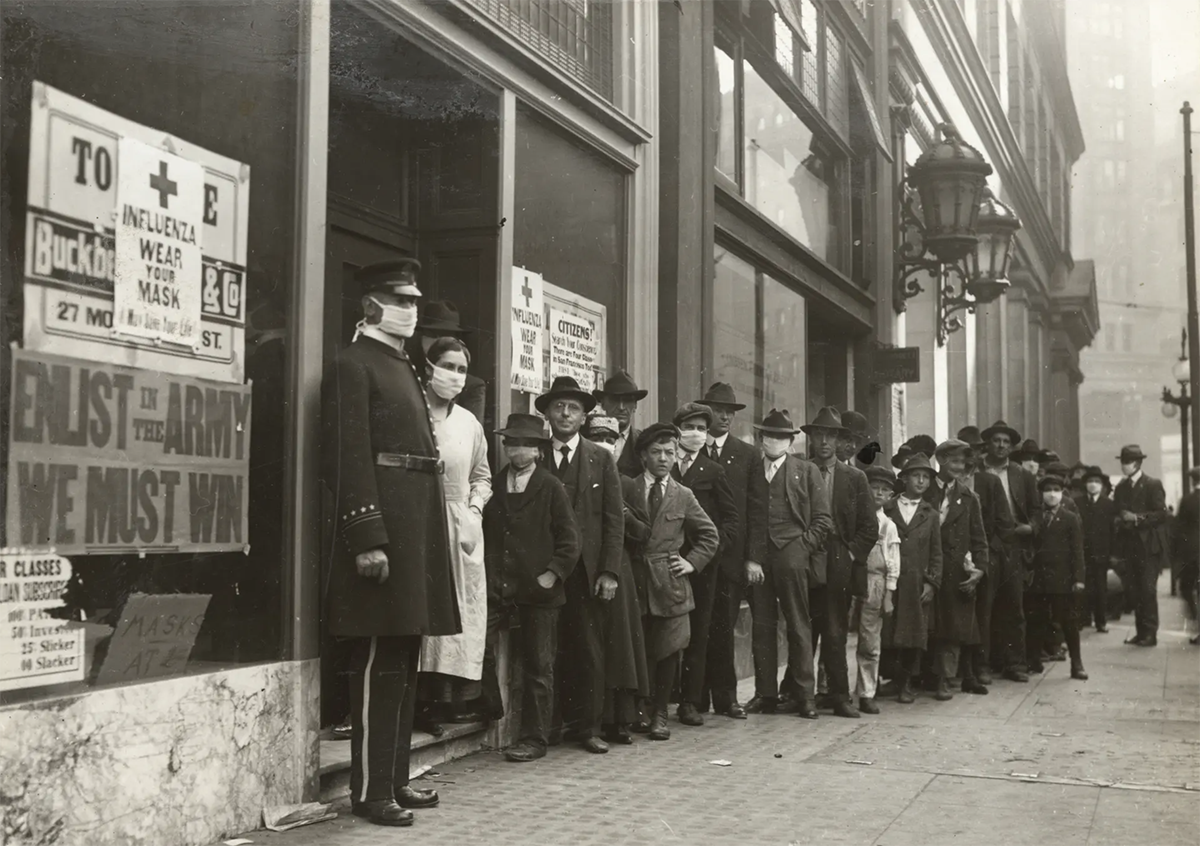 Historical photo of San Francisco residents lining up during the 1918 influenza pandemic.