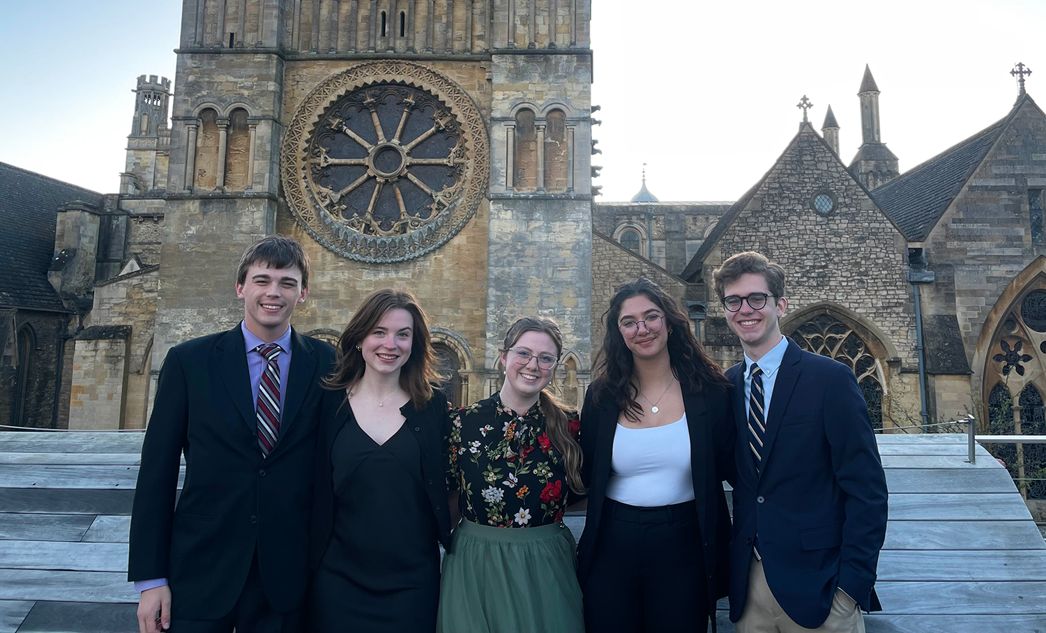 Students pose for a picture in front of a historic monument.